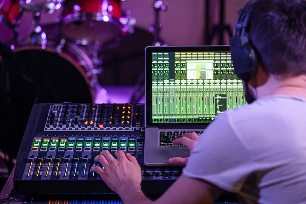Digital Mixer on a Recording Studio with a computer recording music on the background