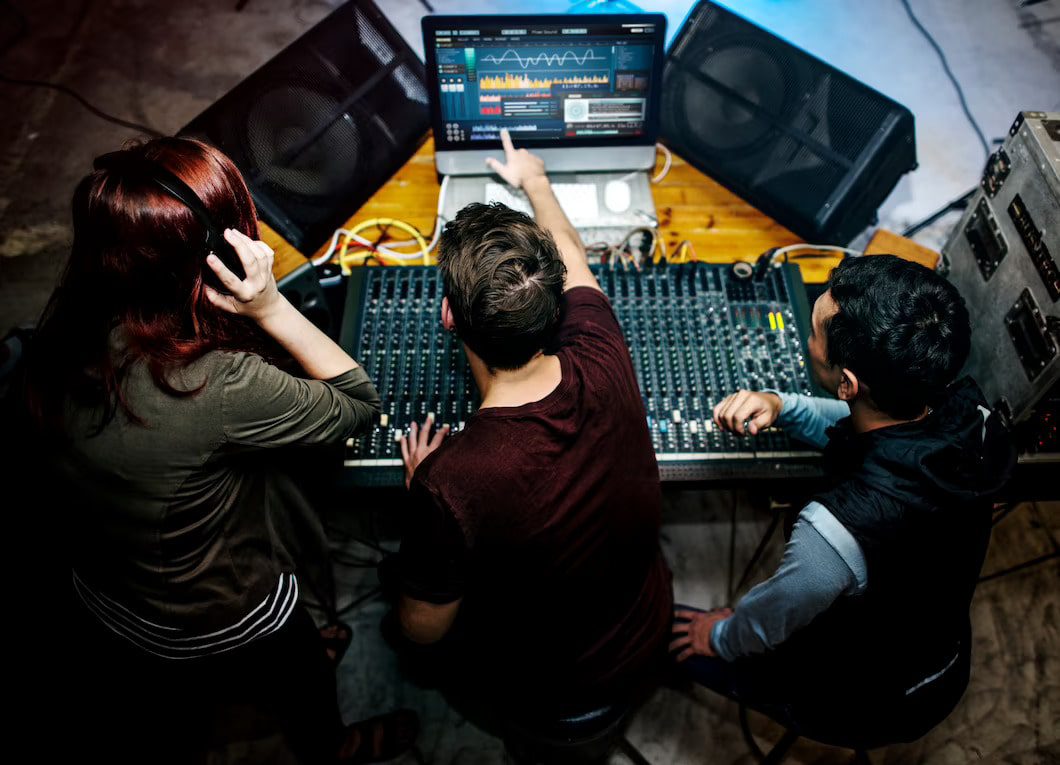 Group of people on a sound mixer station