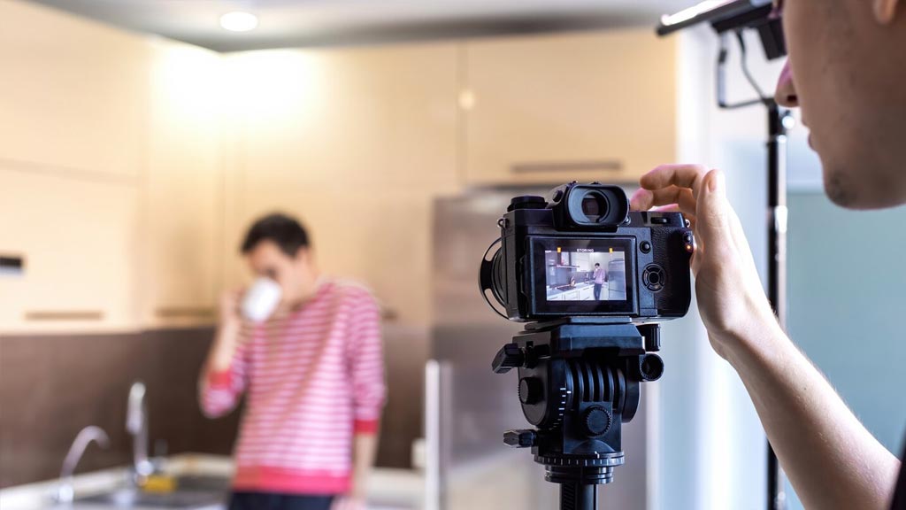 A man video shooting a guy blurred on the background