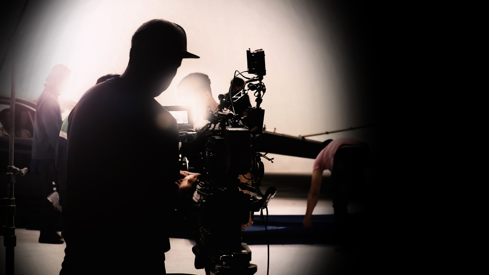 silhouette of a videographer operating a professional cinema camera