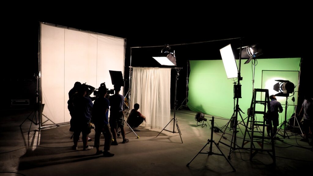 film crew works in a darkened studio