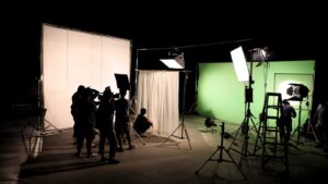 film crew works in a darkened studio